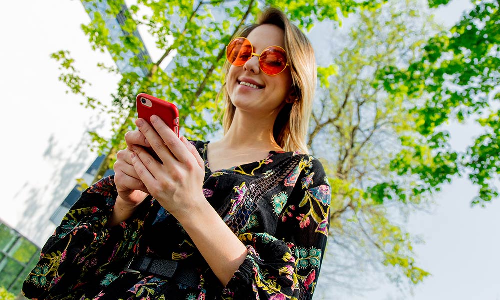 Email Marketing Services (Young Woman Reading Email with Her Phone)